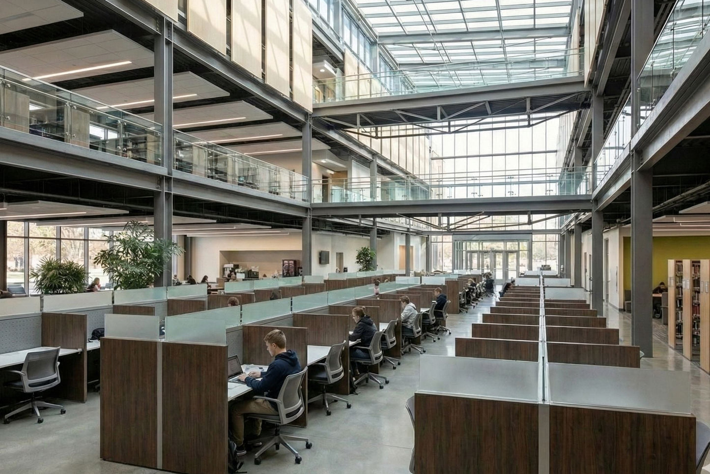 Modern office with glass-walled call center, touchdown and library workstations and cityscape view