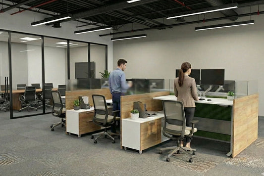 Modern office space with height adjustable desks and glass partitions.