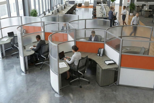 Modern office with glass-walled round cubicle workstations and employees using computers.