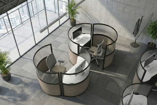 Modern office setup with round workstations and large windows
