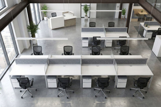 Modern office benching layout with desks and chairs in a large open space.