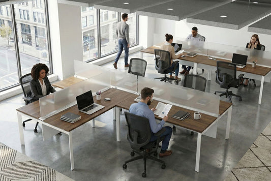Modern office space with people working at desks and computers.