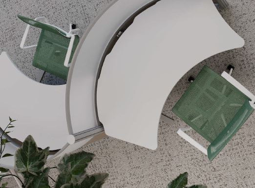 White curved office desk with green office chairs on a gray floor.