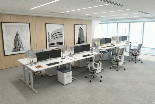 Modern office with desks, chairs, and computer monitors arranged in a row.