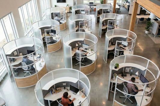 Modern office space with circular workstations and large windows.