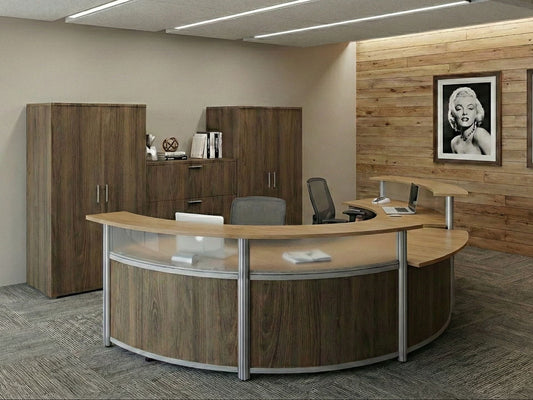 Modern office interior with a curved reception desk, wooden cabinets, and framed pictures on the wall.