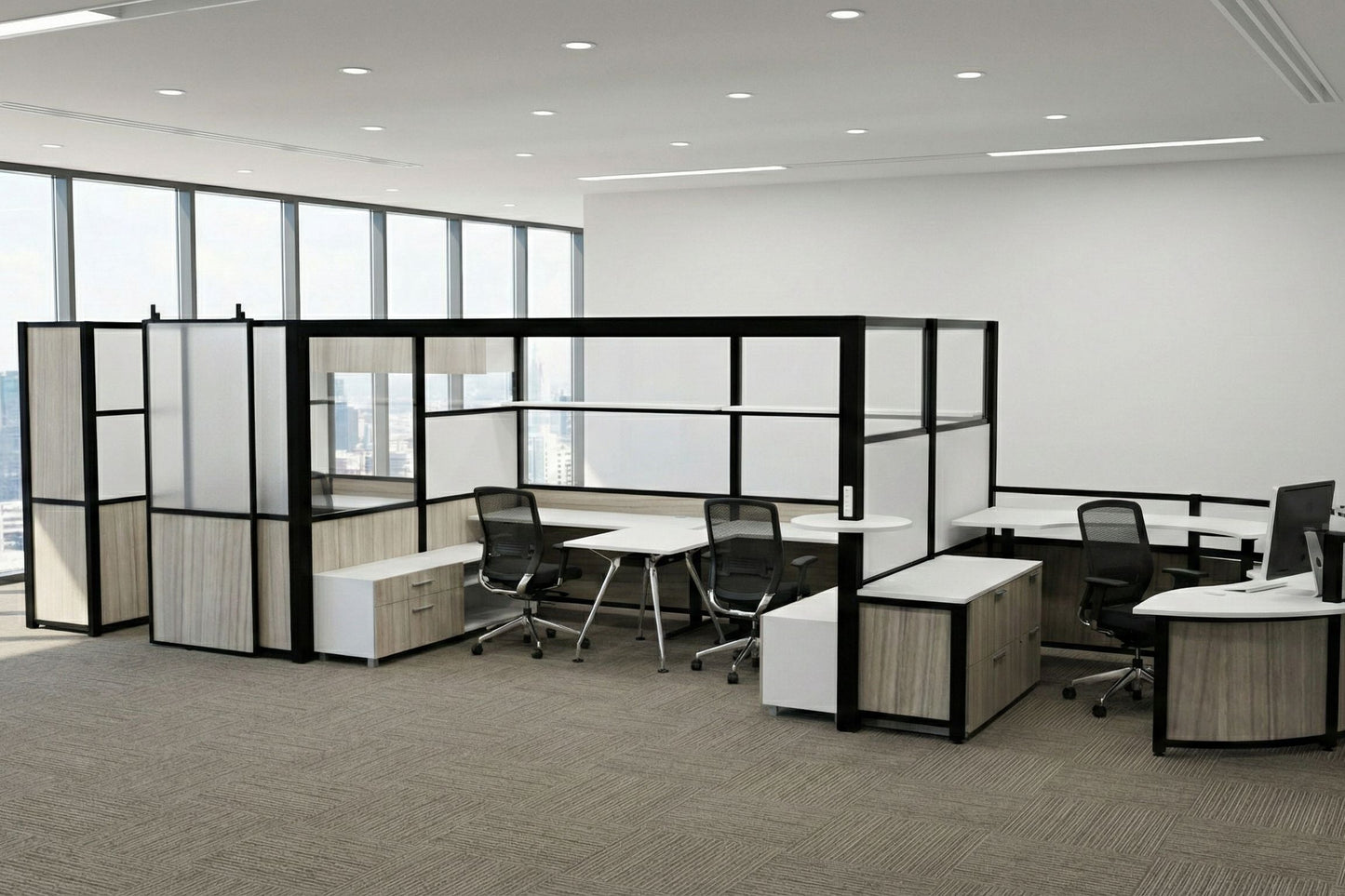 Modern office layout with partitioned workstations and large windows.