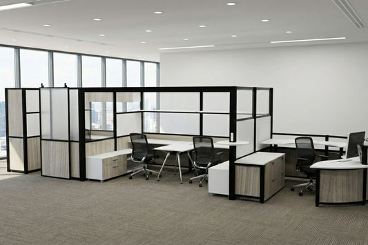 Modern office layout with partitioned workstations and large windows.