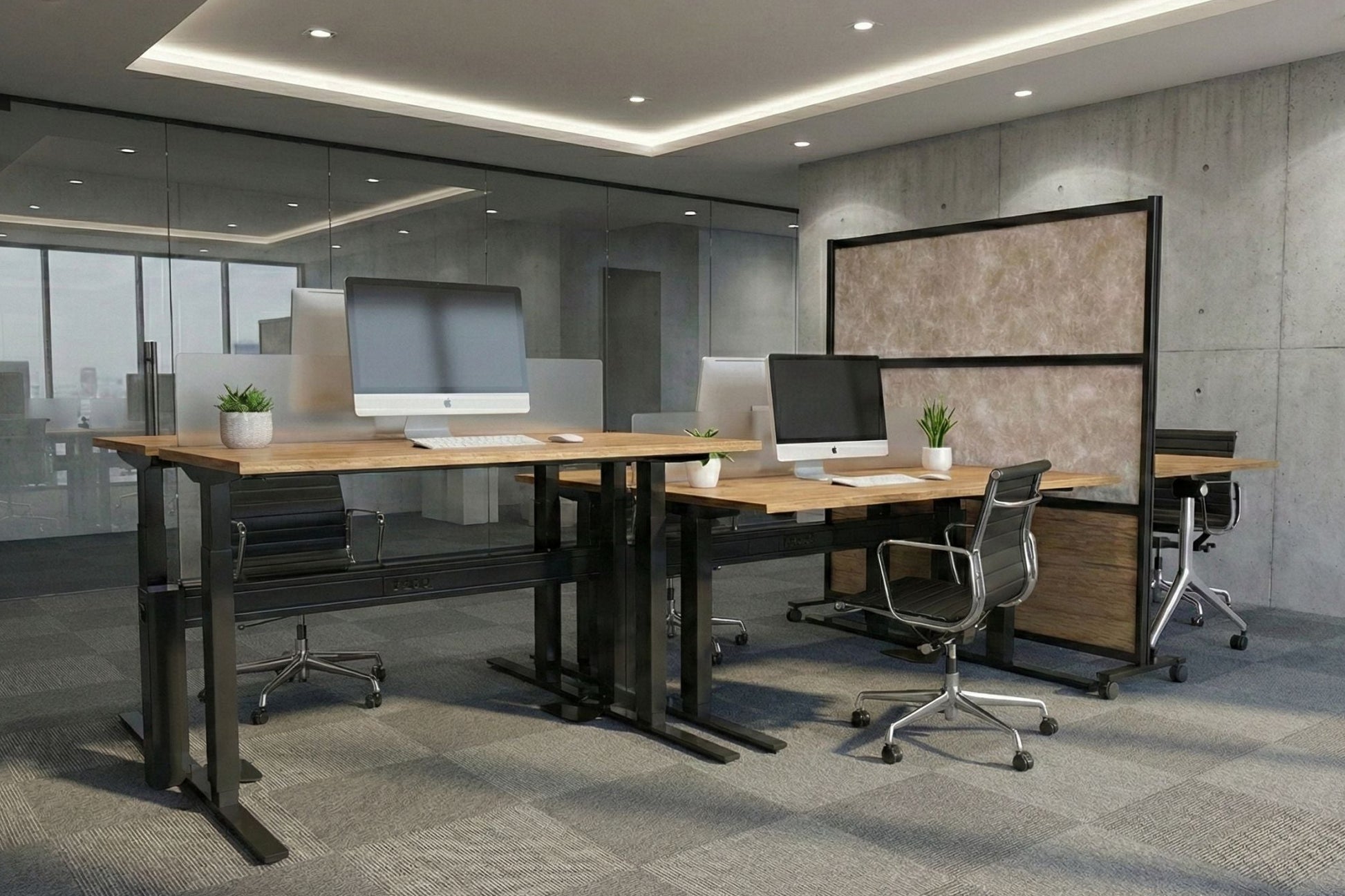 Modern office space with standing desks, chairs, and a large screen in the background.