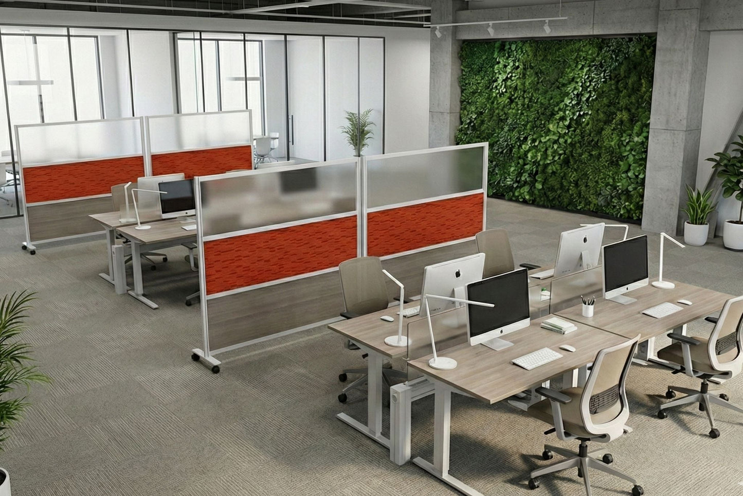 Modern office setup with desks, chairs, and computer monitors in a well-lit room.
